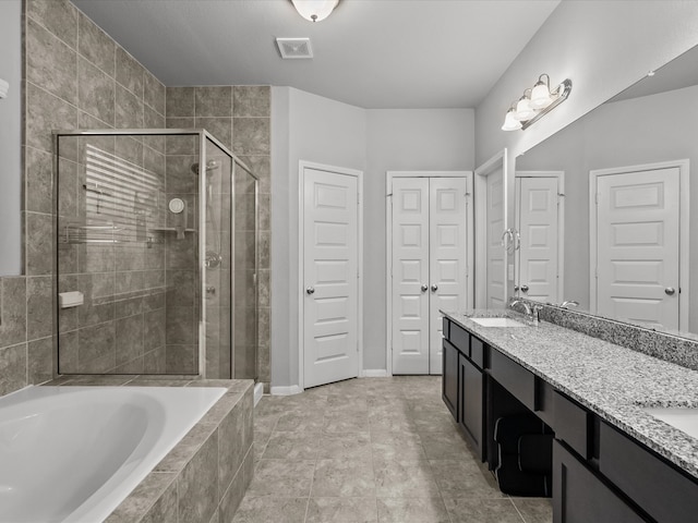 bathroom featuring separate shower and tub, tile patterned flooring, and vanity