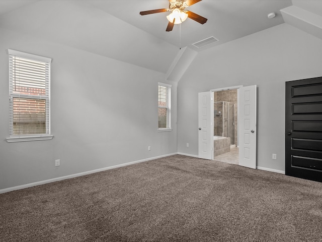 unfurnished bedroom with ceiling fan, lofted ceiling, light carpet, and ensuite bath