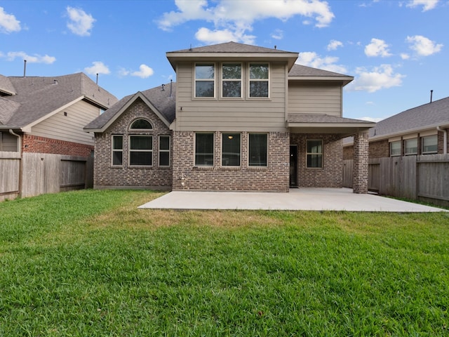 back of house with a yard and a patio