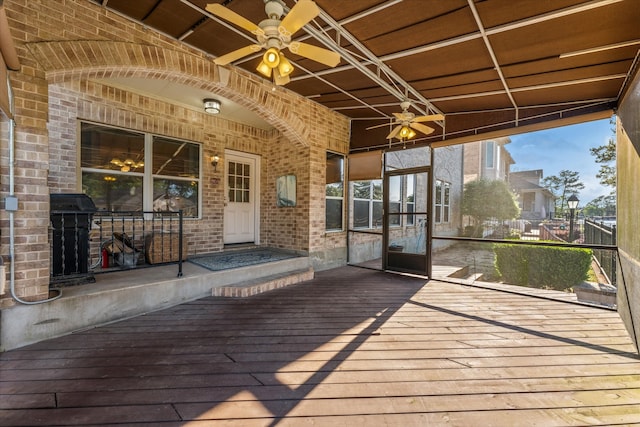 wooden terrace featuring ceiling fan and a grill