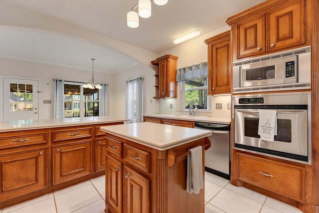 kitchen featuring hanging light fixtures, stainless steel appliances, a notable chandelier, backsplash, and light tile patterned floors