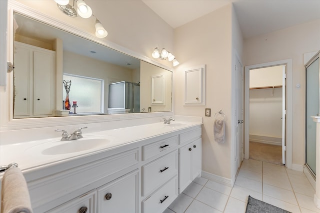 bathroom with tile patterned flooring, vanity, and an enclosed shower