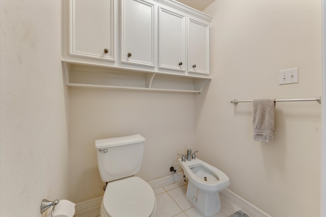 bathroom with tile patterned flooring, a bidet, and toilet