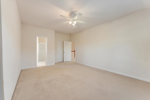 empty room with ceiling fan and light colored carpet