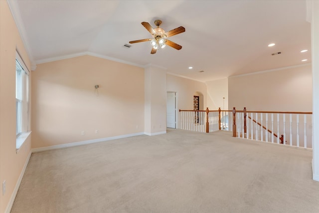 unfurnished room with ceiling fan, light colored carpet, crown molding, and vaulted ceiling