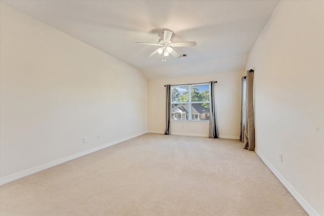 carpeted empty room featuring ceiling fan and vaulted ceiling