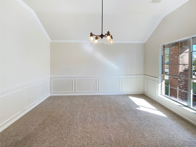 spare room featuring carpet flooring, vaulted ceiling, crown molding, and an inviting chandelier