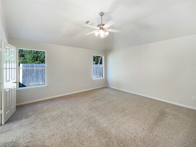 unfurnished room with carpet flooring, ceiling fan, and a healthy amount of sunlight