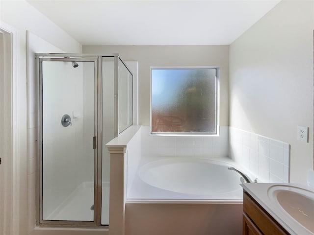 bathroom featuring vanity and plus walk in shower