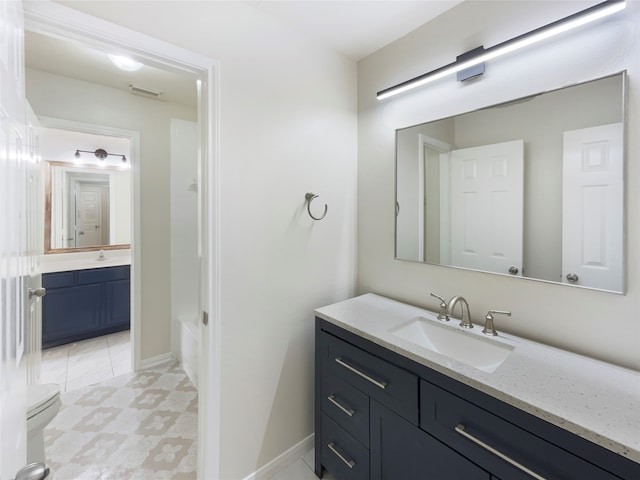 bathroom with vanity and toilet