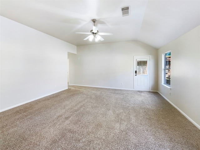 empty room with carpet flooring, ceiling fan, and vaulted ceiling