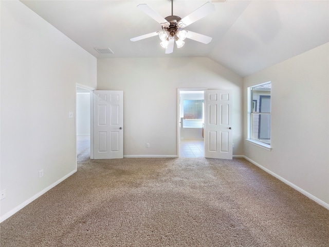 carpeted empty room with ceiling fan and lofted ceiling