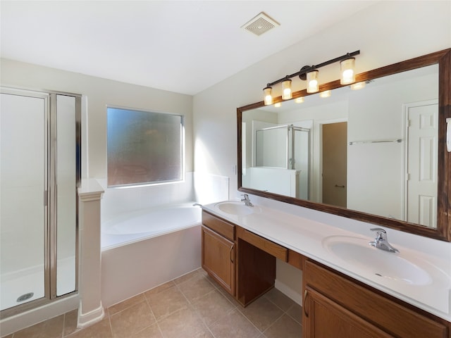 bathroom with tile patterned floors, vanity, and shower with separate bathtub