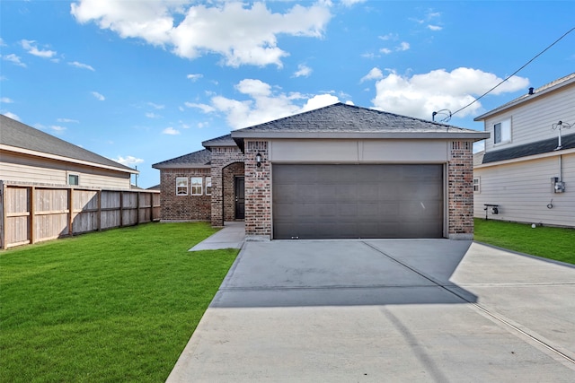 view of front of property with a garage and a front yard