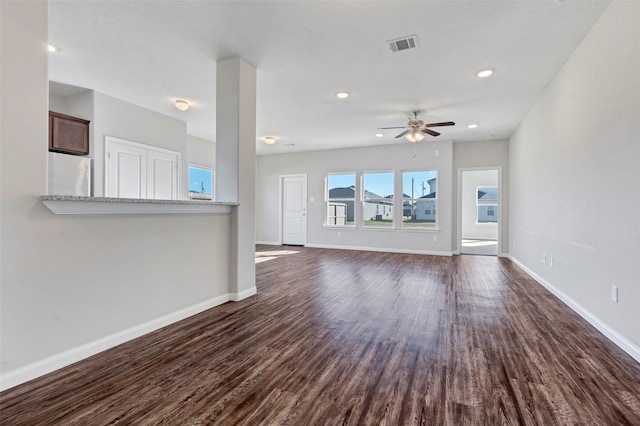 unfurnished living room with ceiling fan and dark hardwood / wood-style flooring