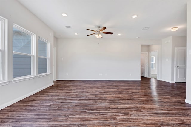 empty room with dark hardwood / wood-style flooring and ceiling fan