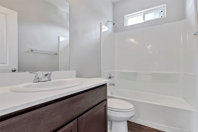 full bathroom with wood-type flooring, vanity, toilet, and  shower combination