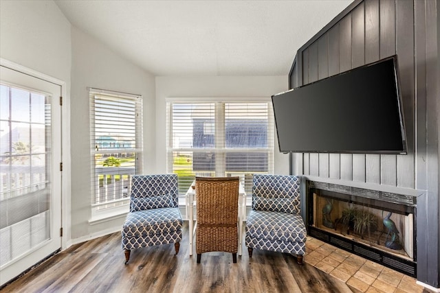 living area with wood-type flooring and vaulted ceiling