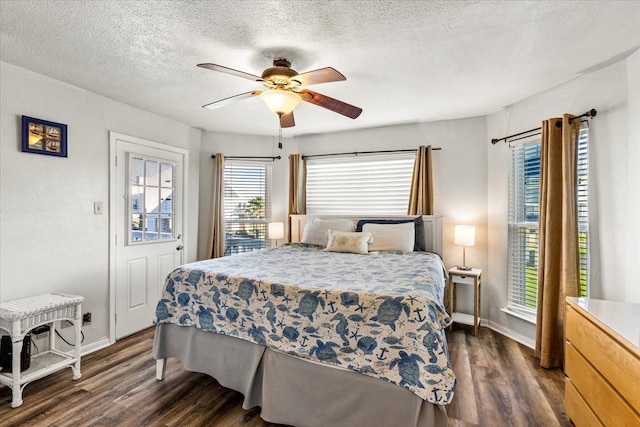 bedroom featuring a textured ceiling, ceiling fan, and dark hardwood / wood-style floors