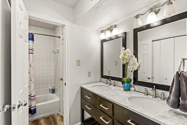 bathroom featuring vanity, hardwood / wood-style floors, and shower / bathtub combination with curtain