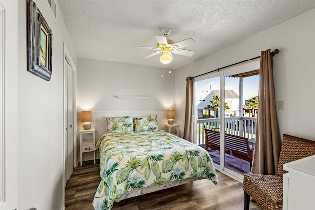 bedroom featuring ceiling fan, dark hardwood / wood-style floors, a textured ceiling, and access to outside