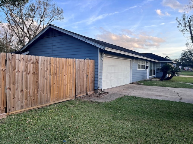 view of home's exterior with a yard and a garage