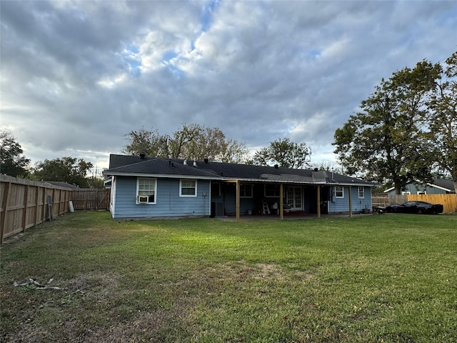 rear view of property featuring a yard