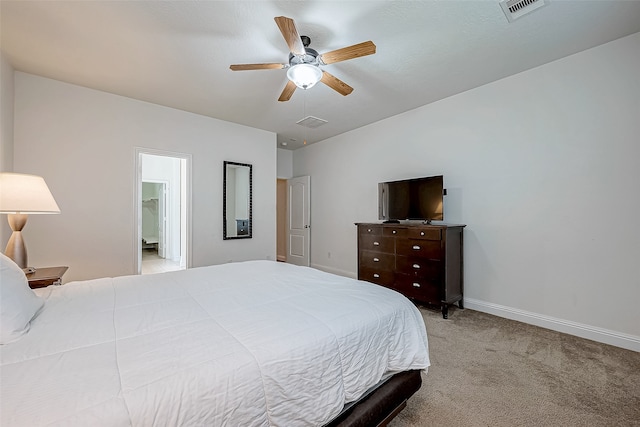 carpeted bedroom with connected bathroom and ceiling fan