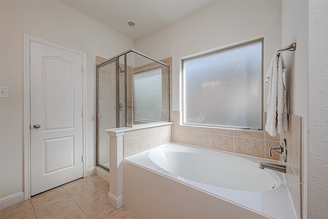 bathroom featuring tile patterned floors and separate shower and tub