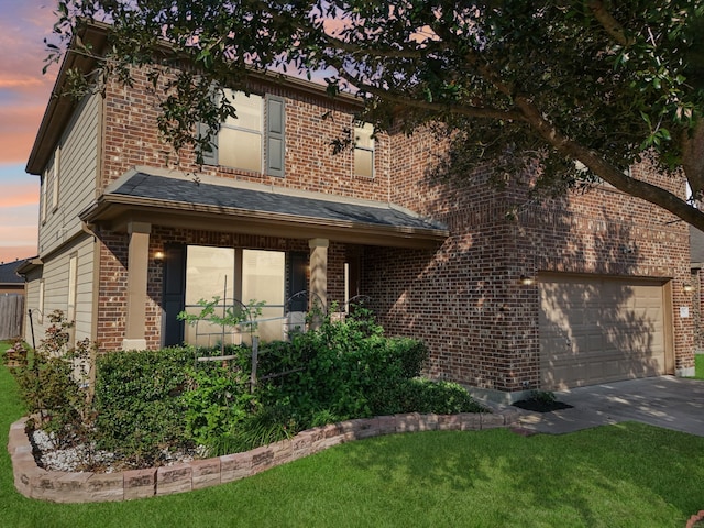 view of front of home featuring a lawn and a garage