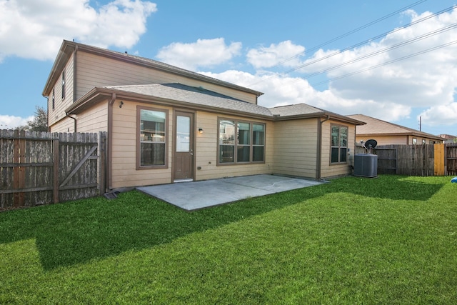 rear view of property with a yard, a patio, and central air condition unit