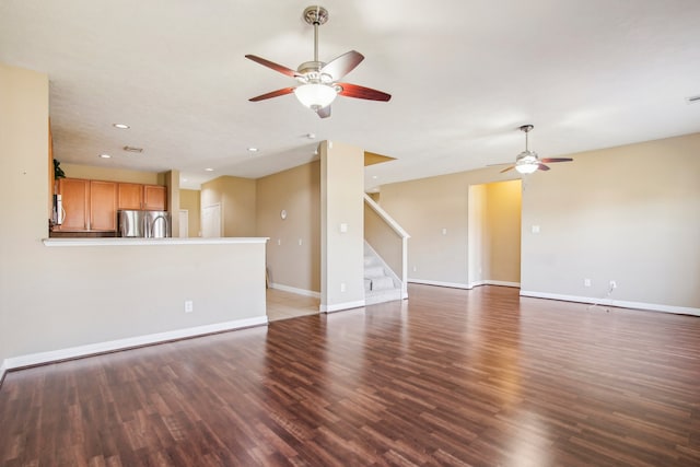 unfurnished living room with ceiling fan and dark hardwood / wood-style flooring