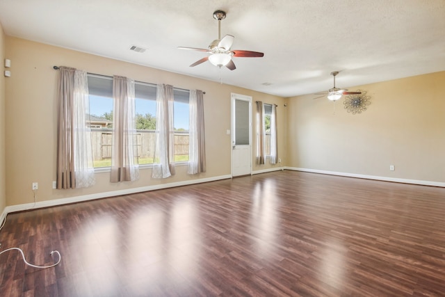 spare room featuring a textured ceiling, dark hardwood / wood-style flooring, and ceiling fan