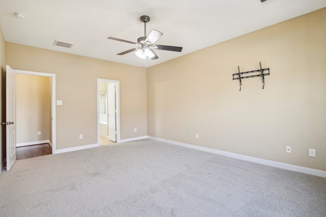 carpeted spare room featuring ceiling fan