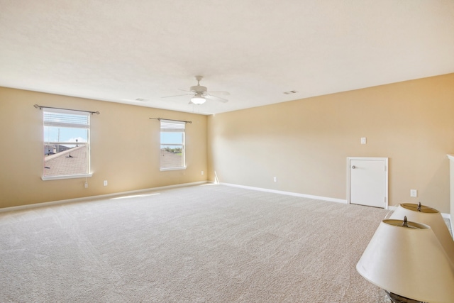 carpeted empty room featuring ceiling fan