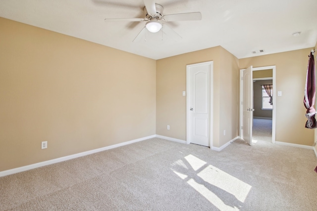 unfurnished bedroom with ceiling fan and light carpet