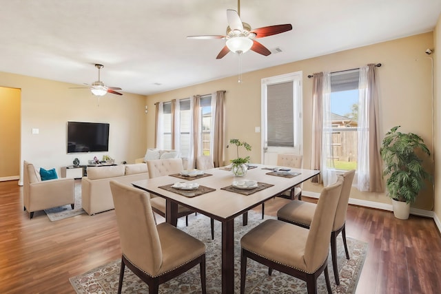 dining room featuring plenty of natural light, dark wood-type flooring, and ceiling fan