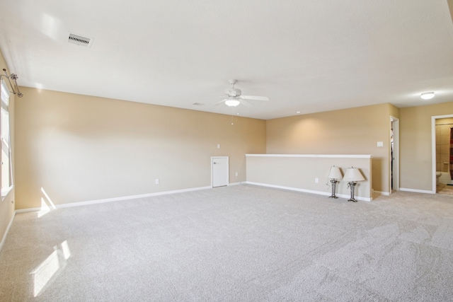 carpeted spare room with ceiling fan