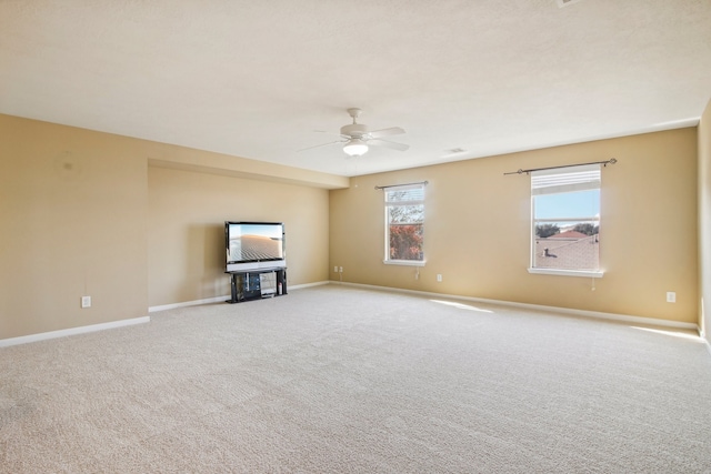 unfurnished living room with ceiling fan and light carpet