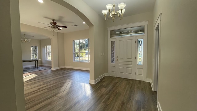 entryway with dark wood-type flooring and ceiling fan with notable chandelier