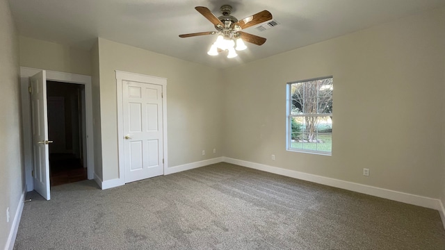 unfurnished bedroom featuring carpet flooring, a closet, and ceiling fan