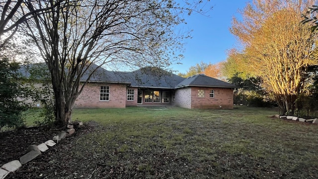 back of house featuring a yard