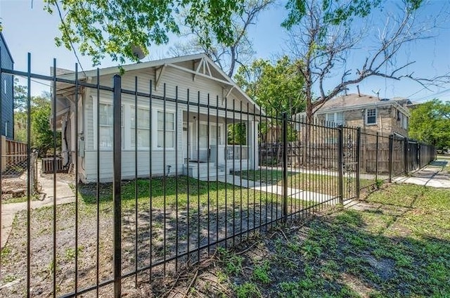 view of gate with a lawn