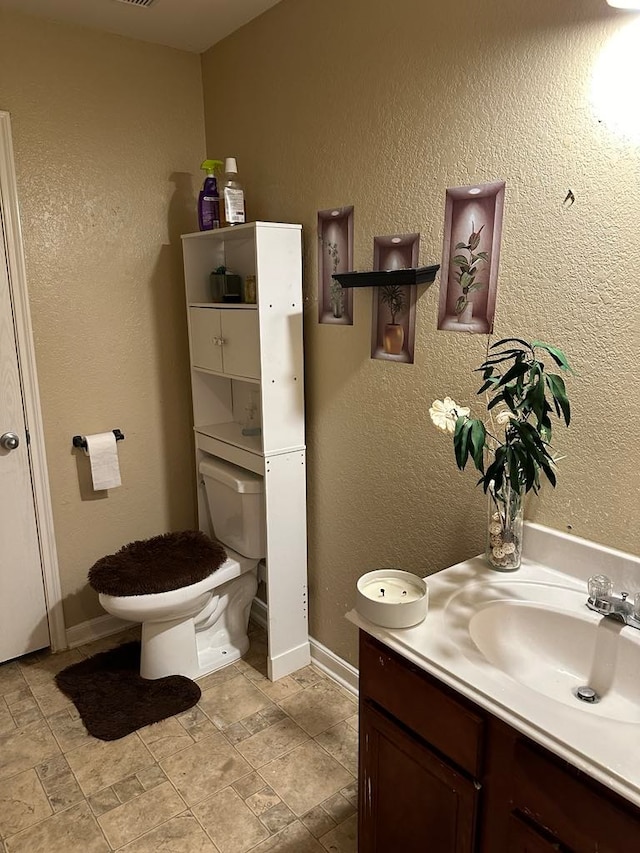 bathroom with vanity and toilet