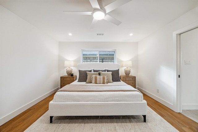 bedroom with ceiling fan and light wood-type flooring