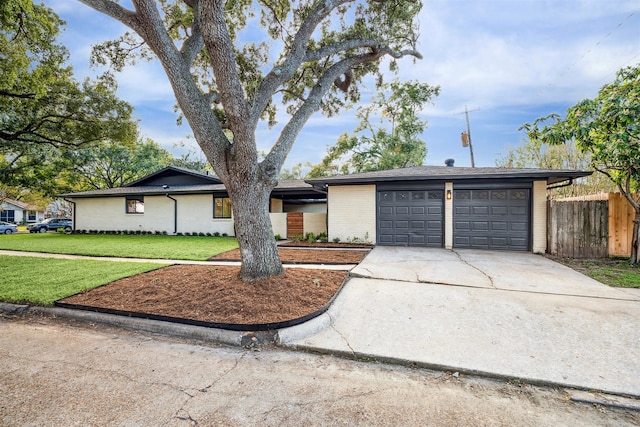 single story home featuring a front yard and a garage