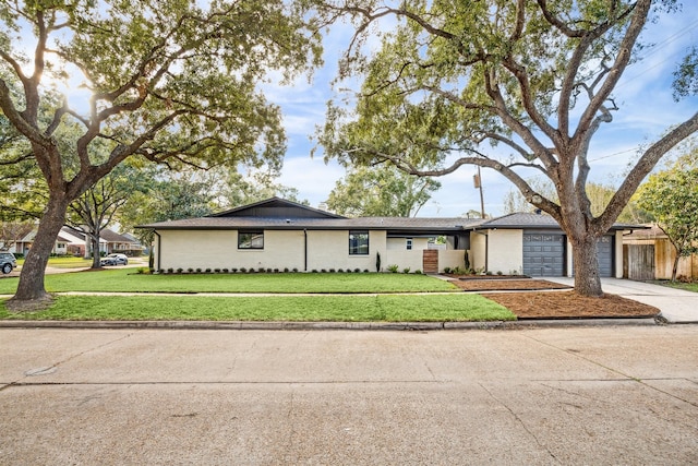 single story home featuring a front yard and a garage