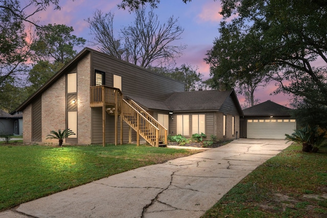 view of front of home featuring a garage and a lawn