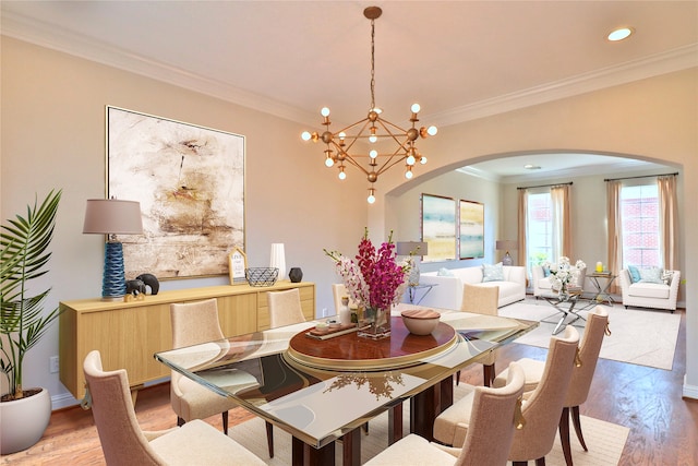 dining room featuring a chandelier, crown molding, and light hardwood / wood-style floors