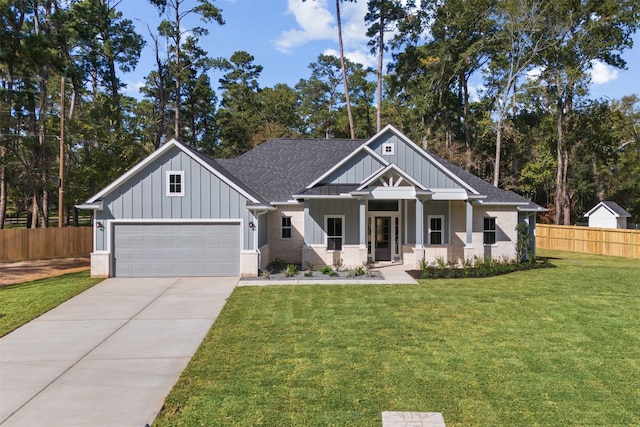 view of front of house featuring a front lawn, covered porch, and a garage